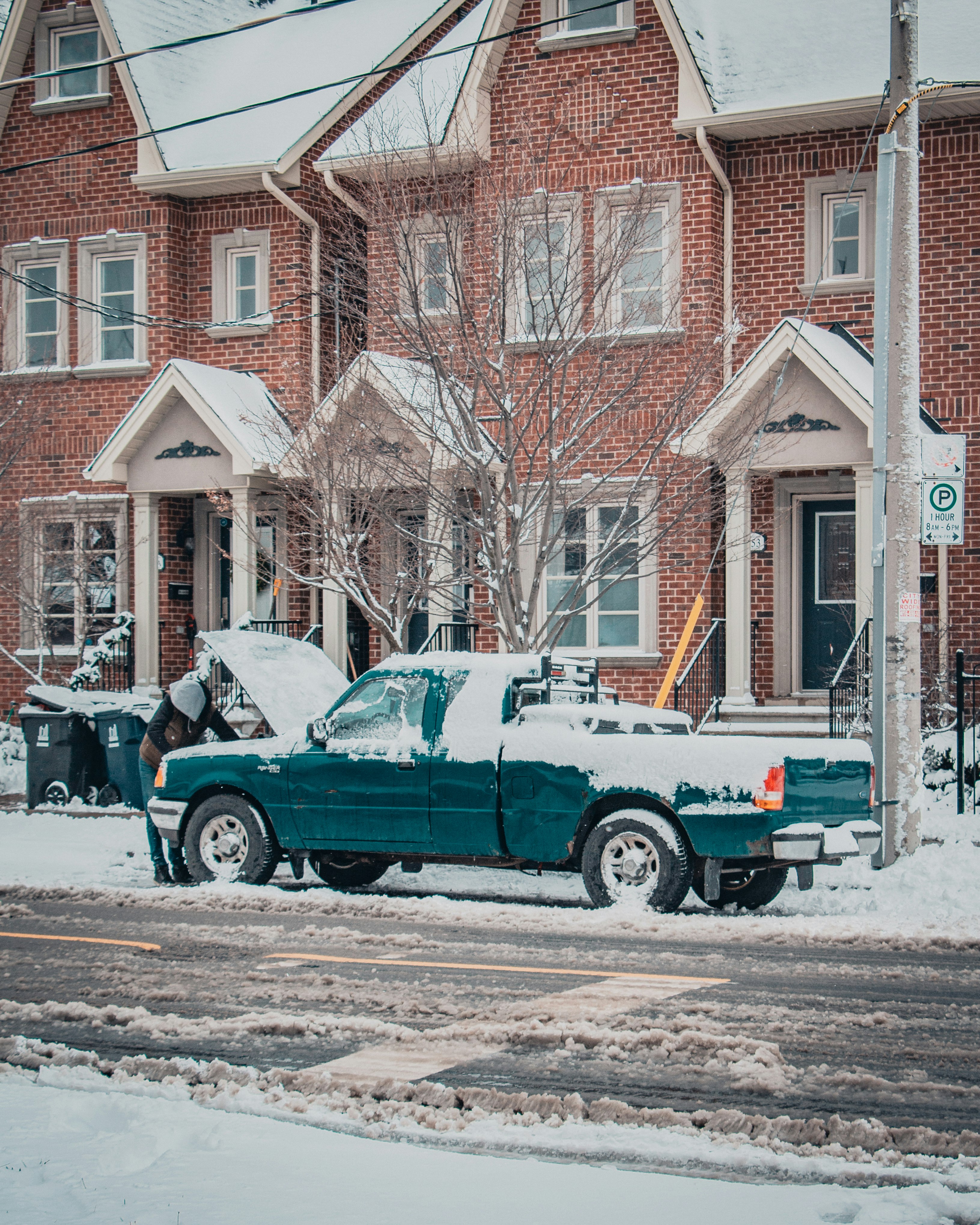 blue car parked beside brown concrete building during daytime